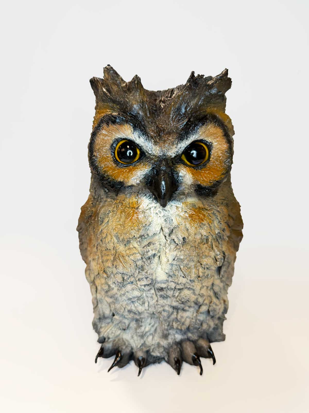 Realistic owl sculpture on a white background made with Pal Tiya Premium cement clay